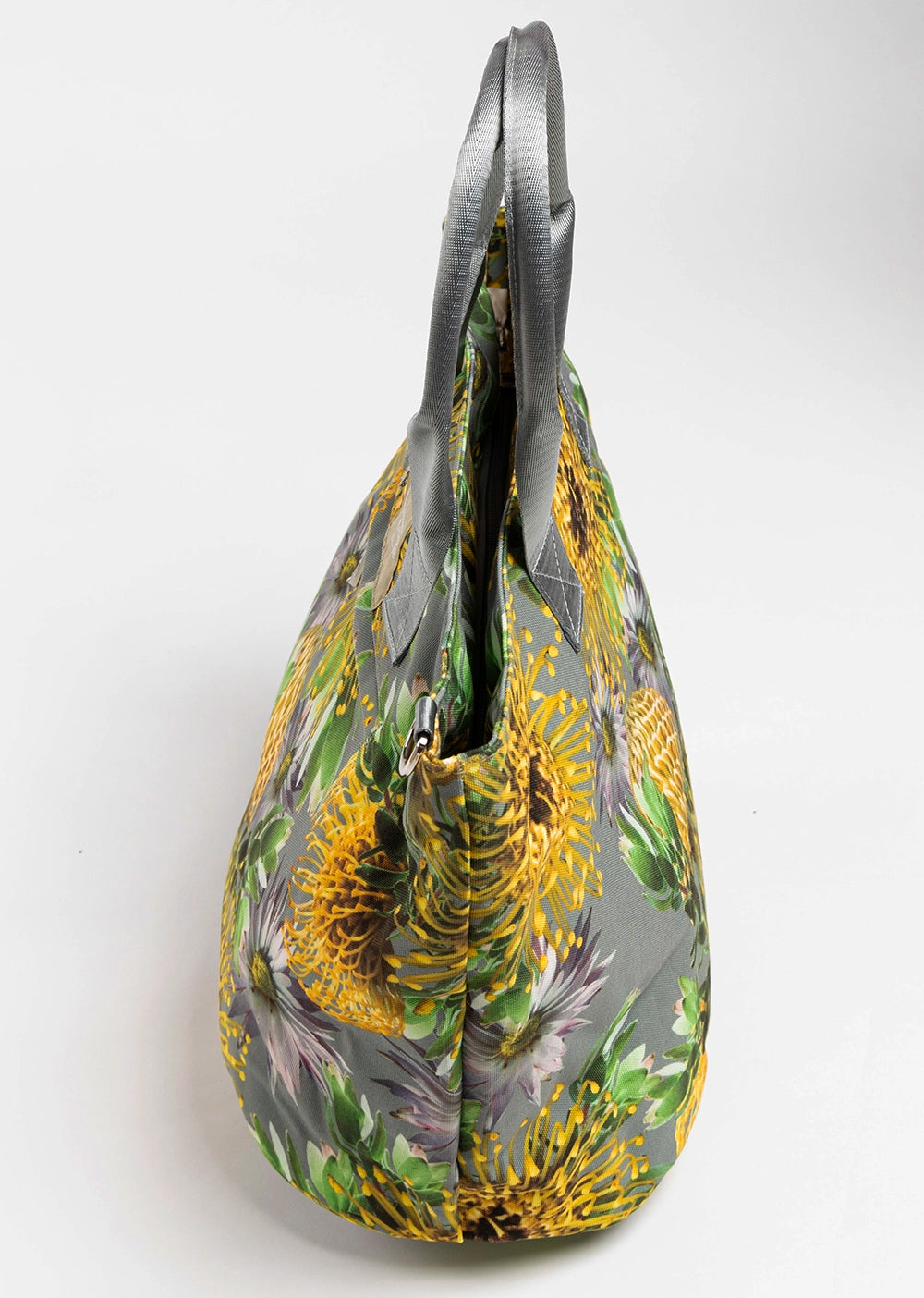A large floral canvas tote bag - side view. The bag is yellow and grey.