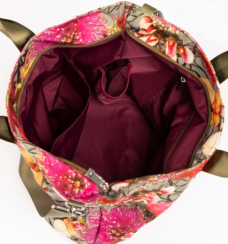 The open Florence bright canvas tote bag showing the deep red waterproof lining with open and zip pockets including a bottle pocket.