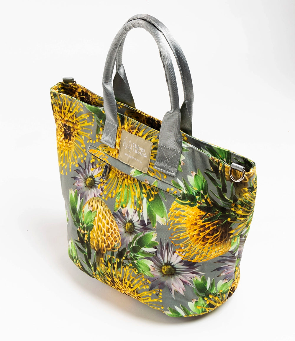 Helena, the large floral canvas tote bag from Wild Things lifestyle.  The flowers are pincushion Proteas in yellow on a grey background.