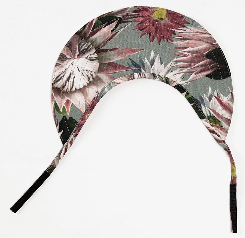 The Bernadette protea sun visor hat lying flat on a white surface.