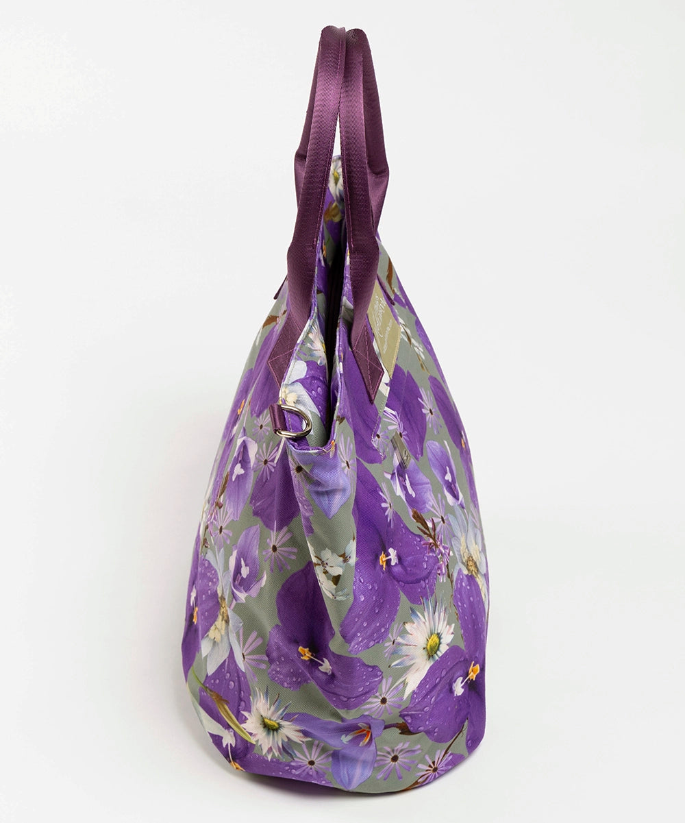 The Phoebe large canvas tote bag from the side. The bag has purple and white flowers.